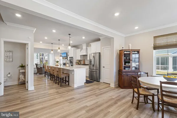 a kitchen with stainless steel appliances kitchen island granite countertop a refrigerator and cabinets