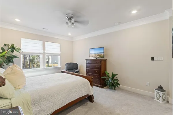 a spacious bedroom with a bed and a chandelier