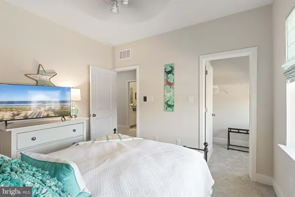 a spacious bedroom with a bed and a cabinets