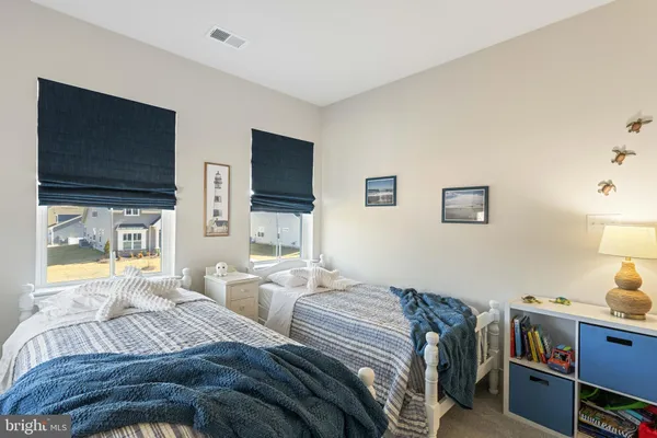 a bedroom with two beds and a flat screen tv