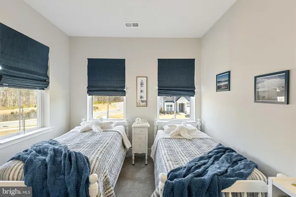 a bedroom with two beds and a window