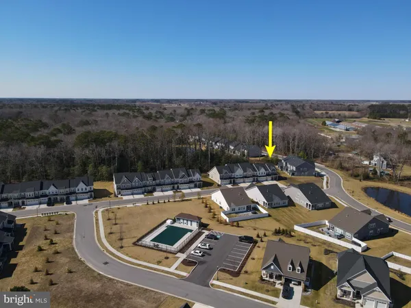 a view of a swimming pool with seating area and furniture