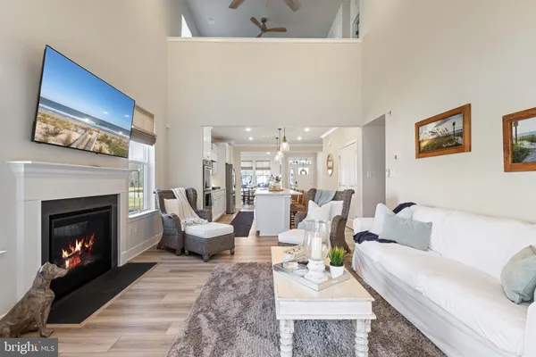 a living room with furniture a fireplace and a wall painting