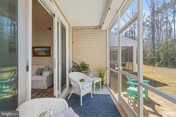a balcony view with a couch and glass door