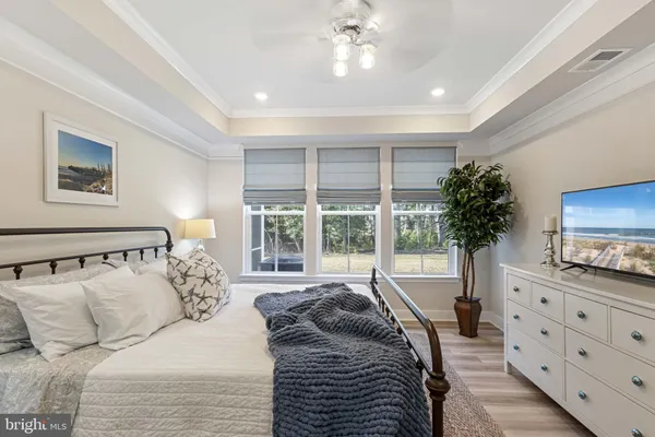 a large bedroom with a bed and a large window