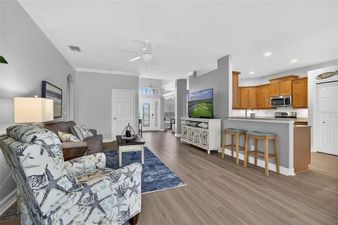 a living room with furniture and a wooden floor