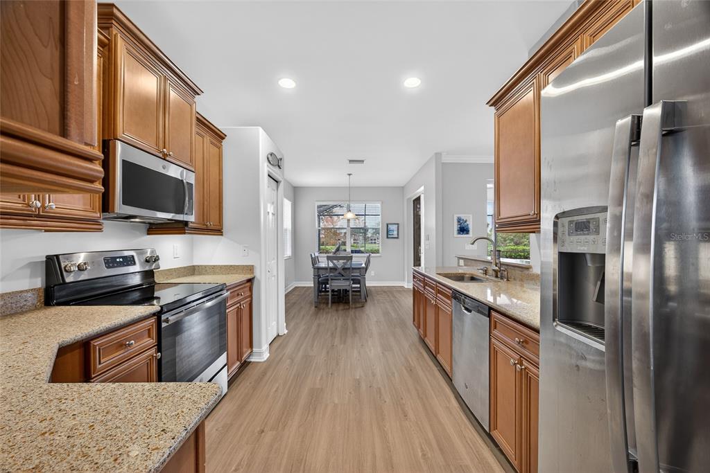25187 Keygrass Court Punta Gorda, FL 33955 - Photo 13 of 54 a kitchen with stainless steel appliances granite countertop lots of counter top space a stove top oven and refrigerator