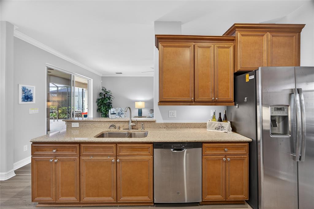 25187 Keygrass Court Punta Gorda, FL 33955 - Photo 14 of 54 a kitchen with stainless steel appliances granite countertop a sink and refrigerator