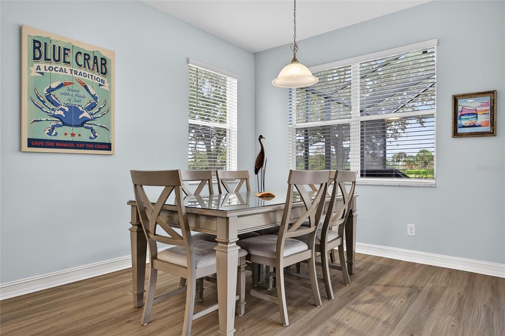 25187 Keygrass Court Punta Gorda, FL 33955 - Photo 17 of 54 a dining room with furniture a painting and wooden floor