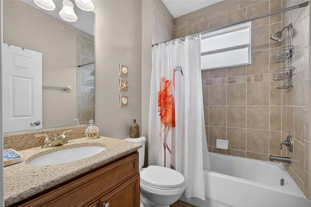 25187 Keygrass Court Punta Gorda, FL 33955 - Photo 24 of 54 a bathroom with a granite countertop sink toilet and shower