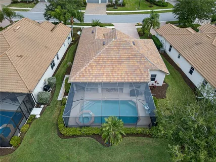 an aerial view of a house with a garden and pool view