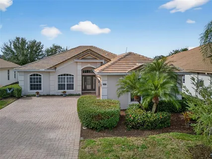a view of a house with backyard porch and sitting area