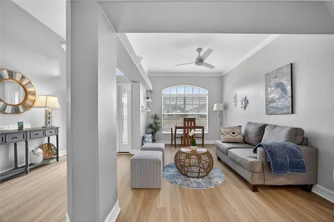 a living room with furniture and wooden floor