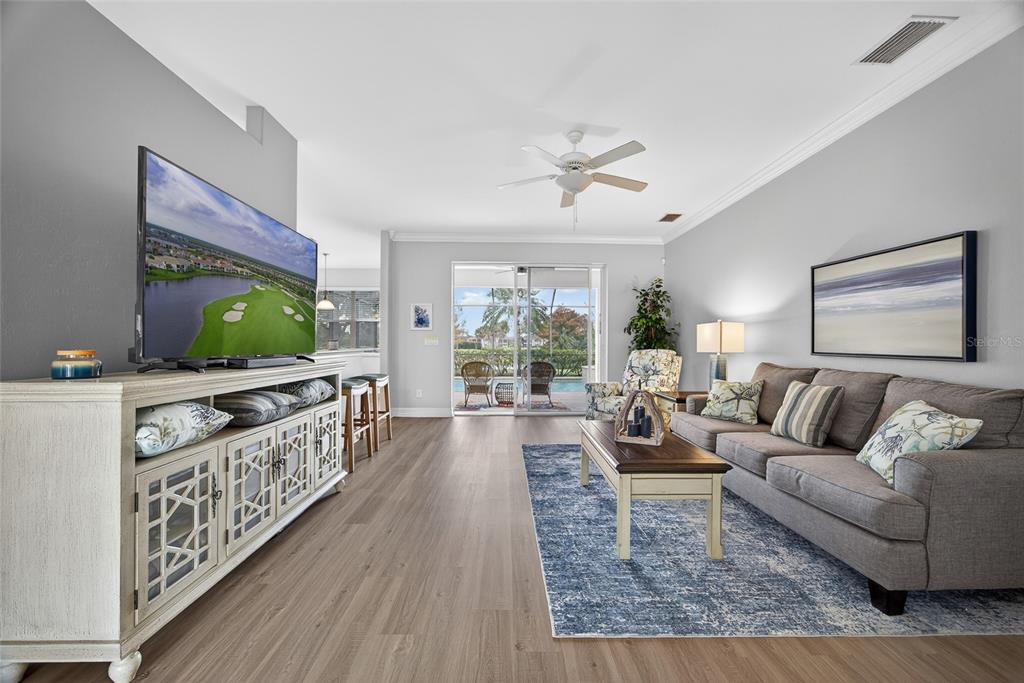 25187 Keygrass Court Punta Gorda, FL 33955 - Photo 9 of 54 a living room with furniture and a flat screen tv