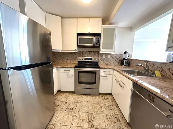 a kitchen with a sink stove and refrigerator
