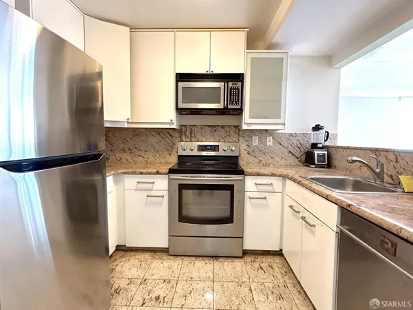 a kitchen with a stove microwave and refrigerator