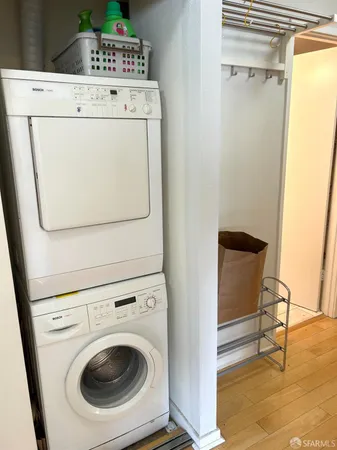 a view of washer and dryer with bathroom in the background