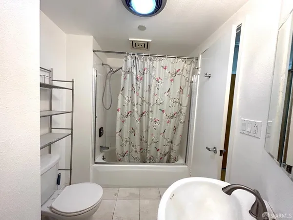 a bathroom with a toilet and a shower