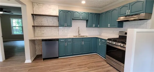 a kitchen with a sink and a stove top oven