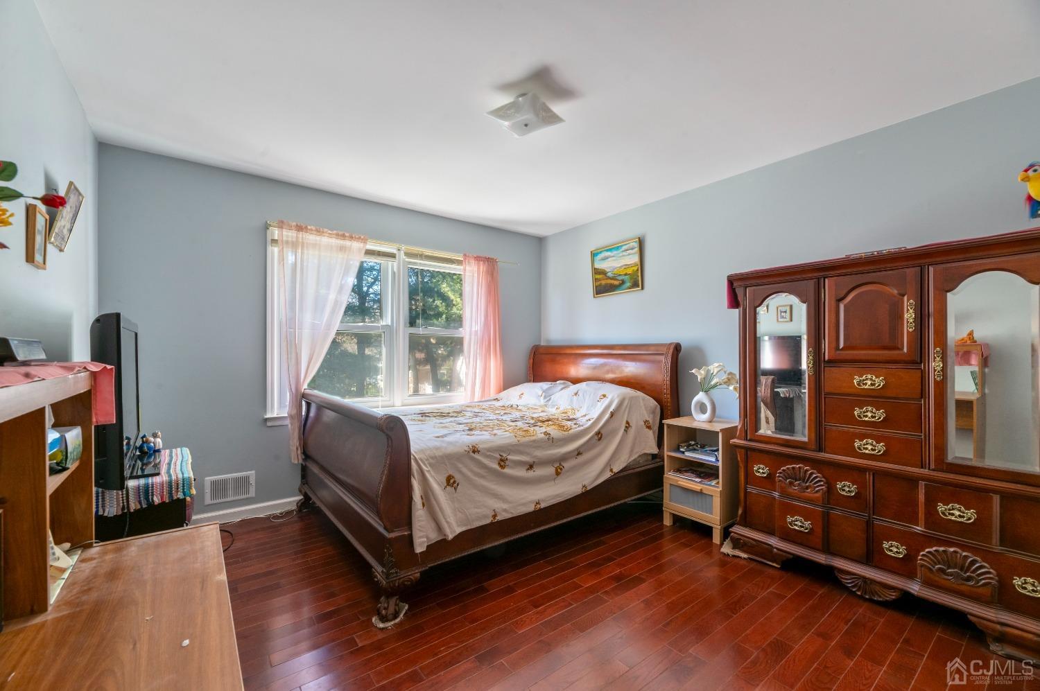 7 Prescott Road East Brunswick, NJ 08816 - Photo 15 of 30 a bedroom with a bed and a tv on the dresser