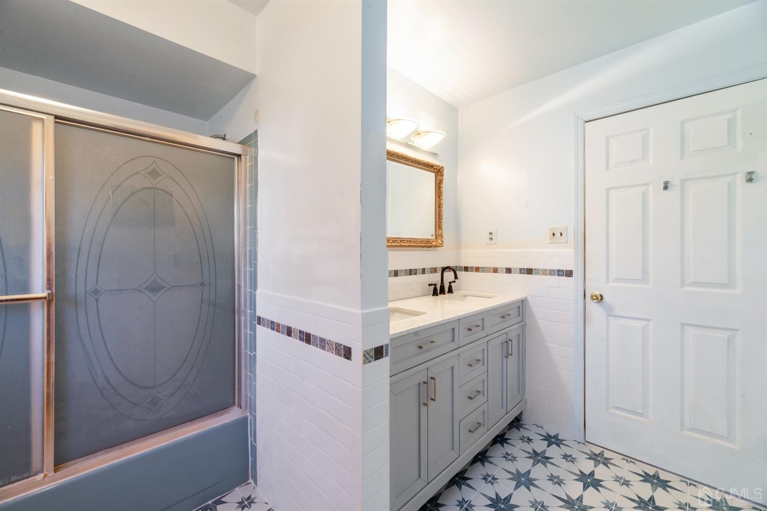 7 Prescott Road East Brunswick, NJ 08816 - Photo 18 of 30 a bathroom with a sink a mirror and a shower