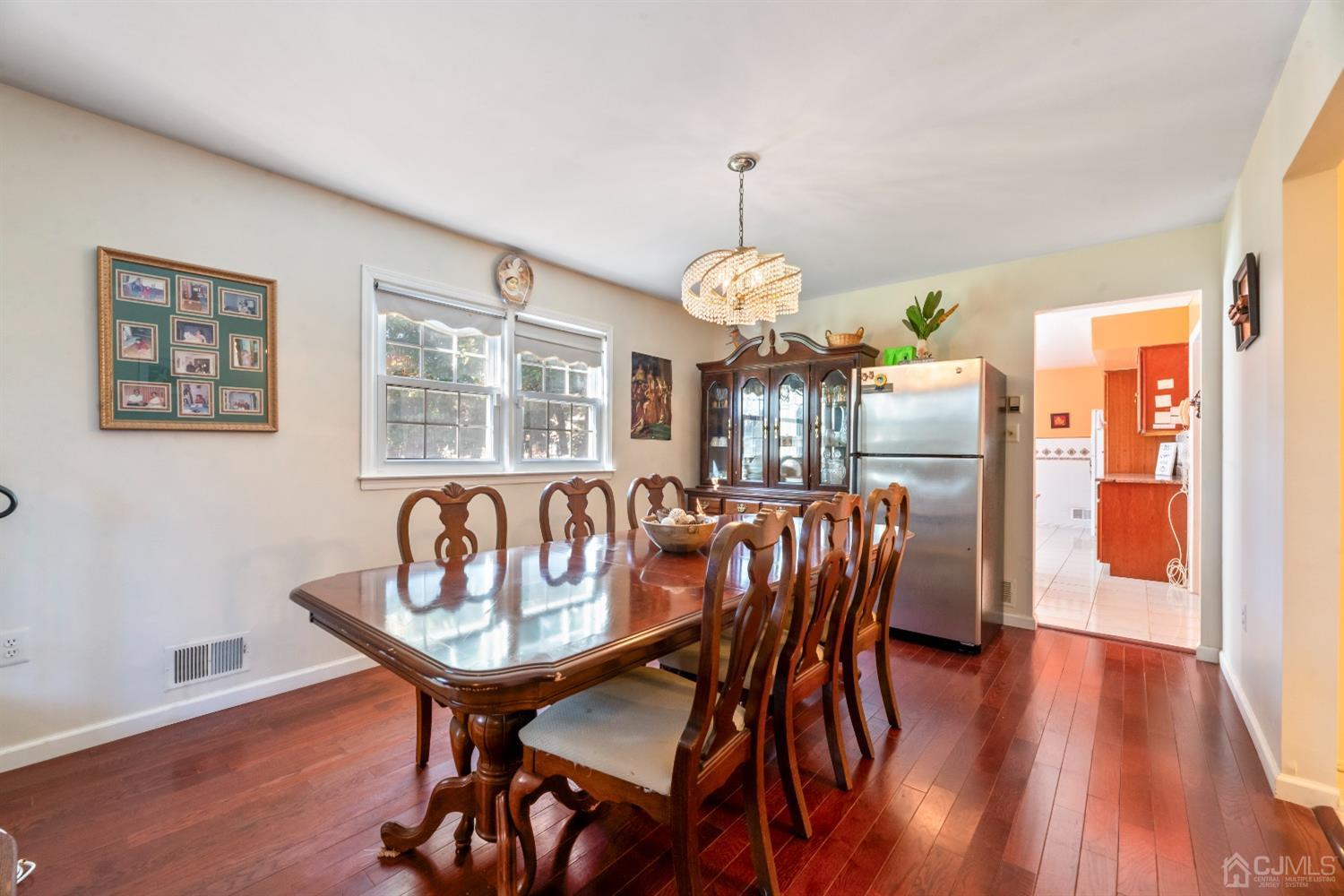 7 Prescott Road East Brunswick, NJ 08816 - Photo 7 of 30 a dining room with furniture a painting and wooden floor