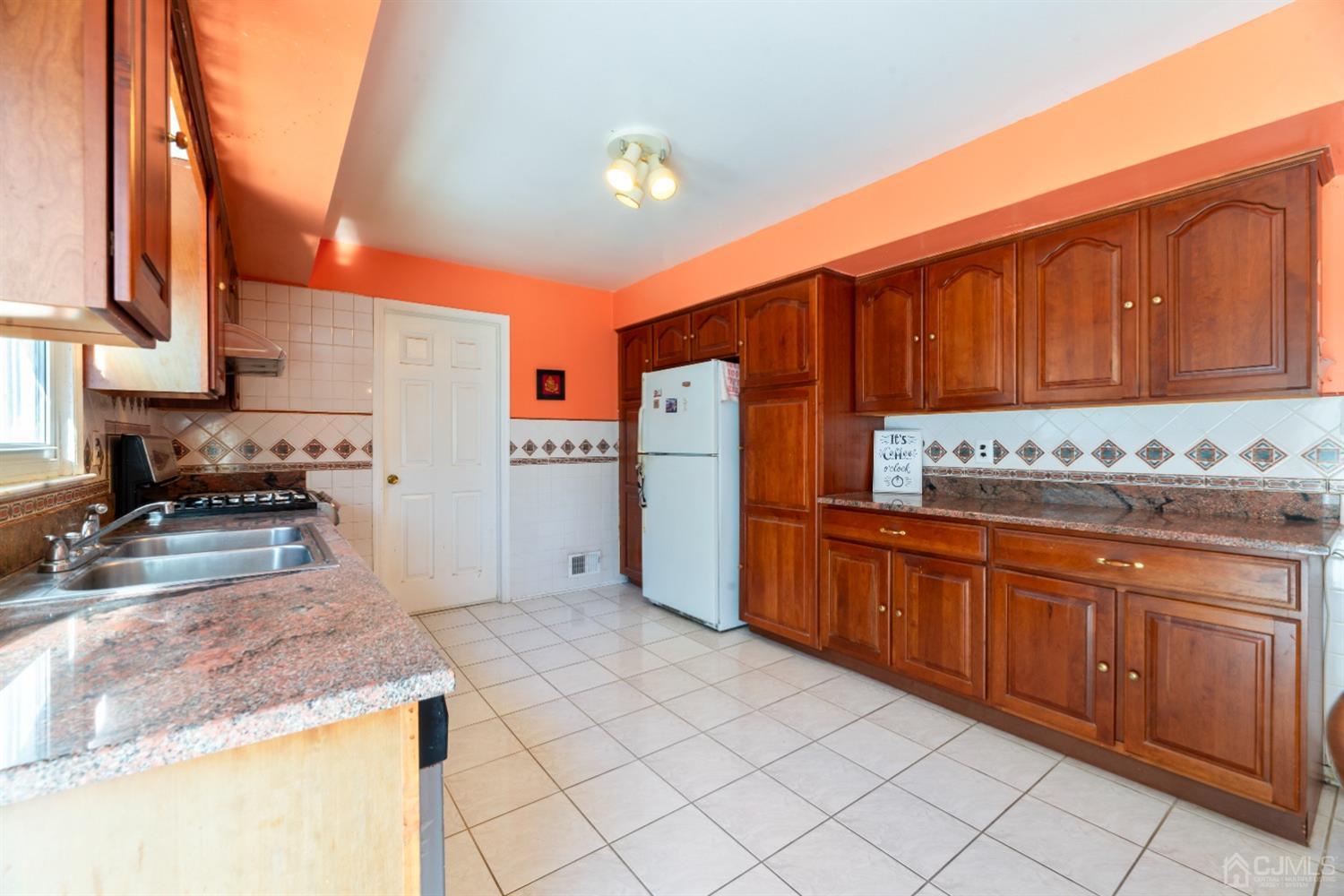 7 Prescott Road East Brunswick, NJ 08816 - Photo 10 of 30 a kitchen with granite countertop a refrigerator and a sink