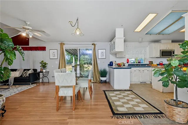 a living room with kitchen island furniture and a potted plant