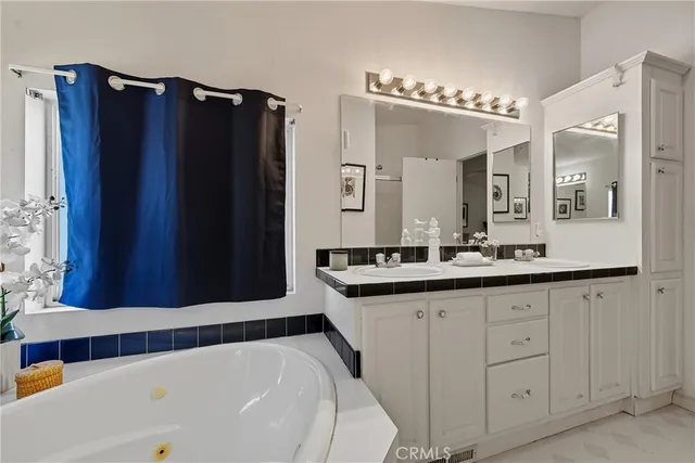 a bathroom with a double vanity sink and mirror