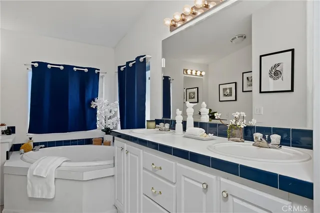 a bathroom with a double vanity sink and a bathtub