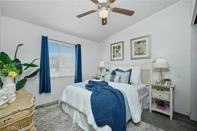 a bedroom with bed and a potted plant