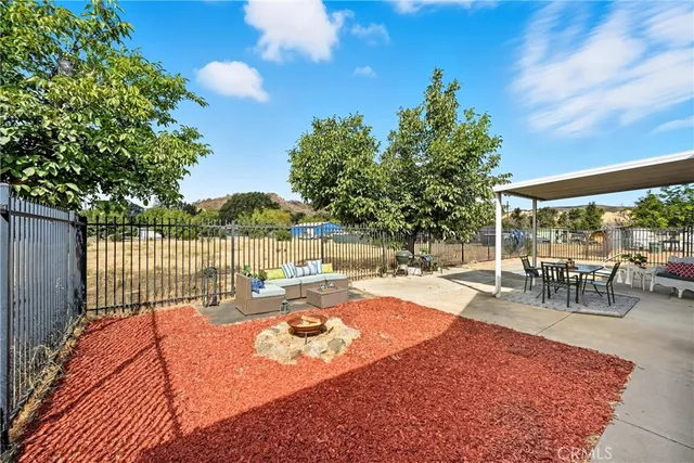 a view of a backyard with sitting area