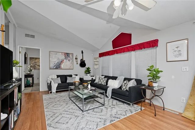 a living room with furniture dining area and a flat screen tv