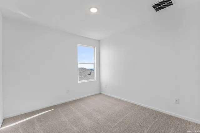 a view of an empty room and a window