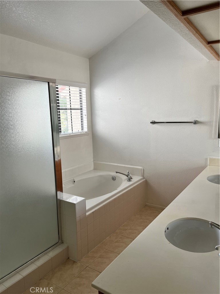 1409 Bodega Way, Unit 4 Diamond Bar, CA 91765 - Photo 11 of 15 a bath tub sitting in a bathroom next to a sink