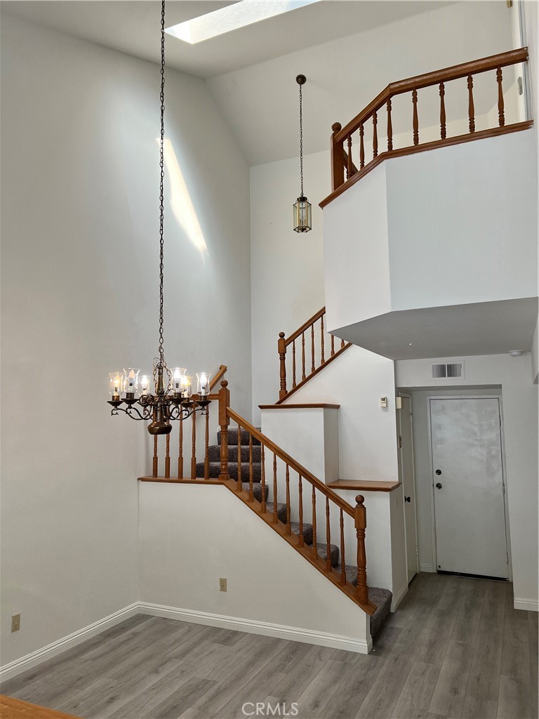 1409 Bodega Way, Unit 4 Diamond Bar, CA 91765 - Photo 8 of 15 a view of staircase and kitchen with wooden floor