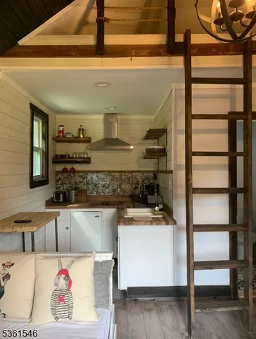 a view of kitchen island with stainless steel appliances kitchen island sink refrigerator and stove