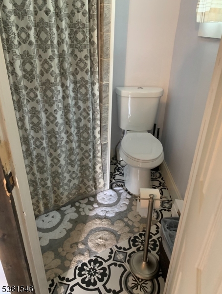 495 Windemere Avenue, Unit A Mount Arlington, NJ 07856 - Photo 5 of 6 a bathroom with a toilet and a shower curtain