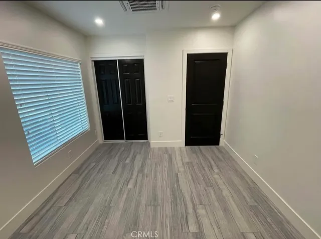 a view of an empty room with closet and closet