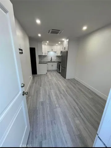 an entryway in a hall with a sink
