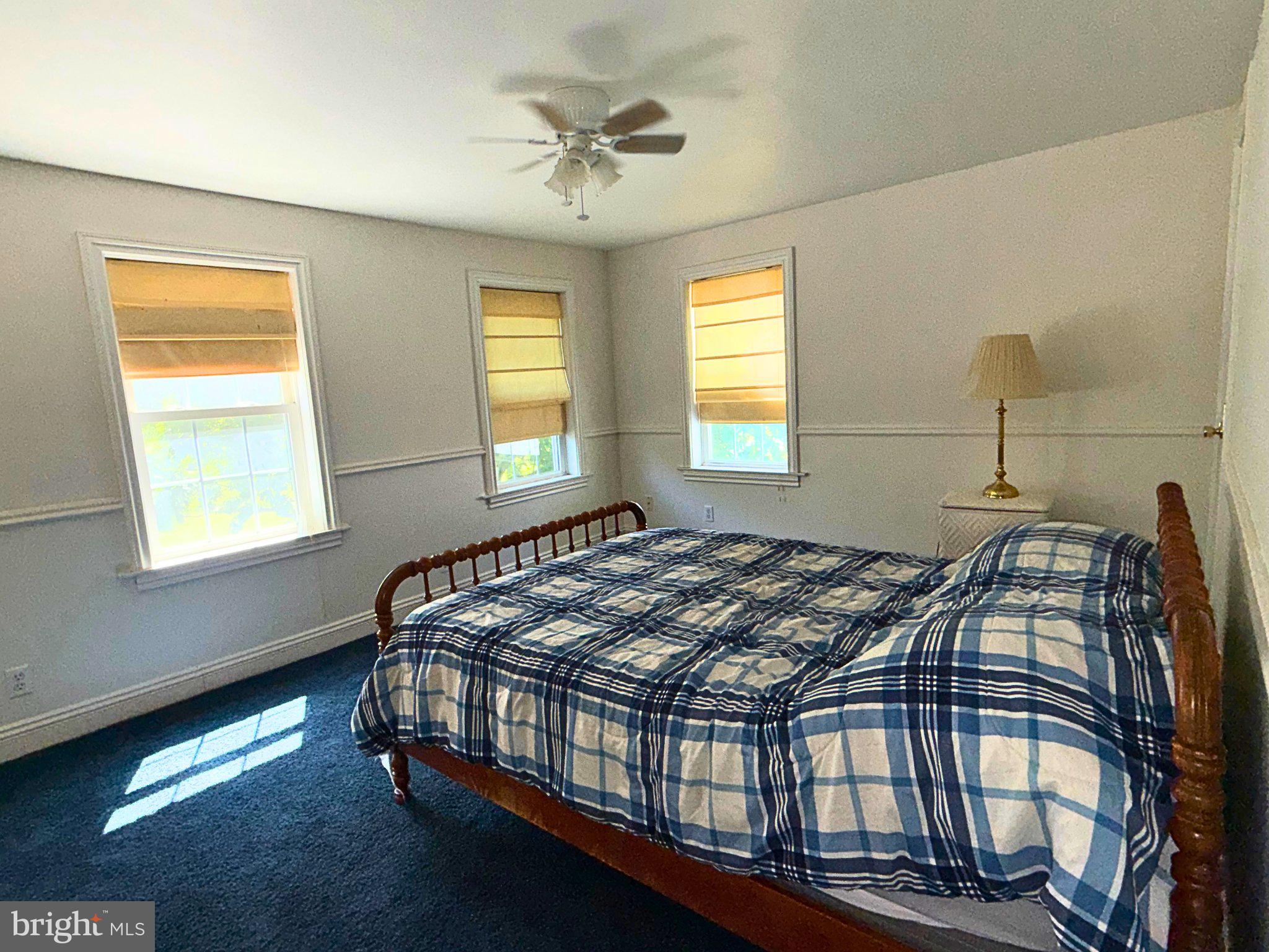 4818 Piney Neck Road Rock Hall, MD 21661 - Photo 19 of 24 a bed sitting in a bedroom next to a window