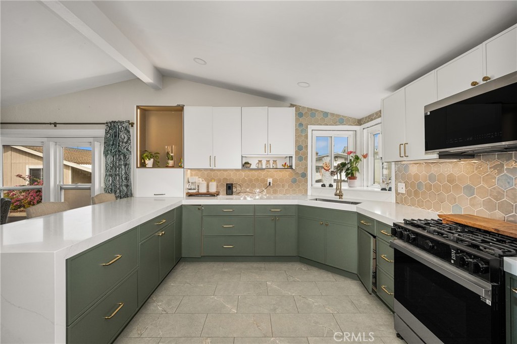 23301 Ridge Rte Drive, Unit 56 Laguna Hills, CA 92653 - Photo 11 of 44 a kitchen with stainless steel appliances granite countertop a sink and a stove top oven