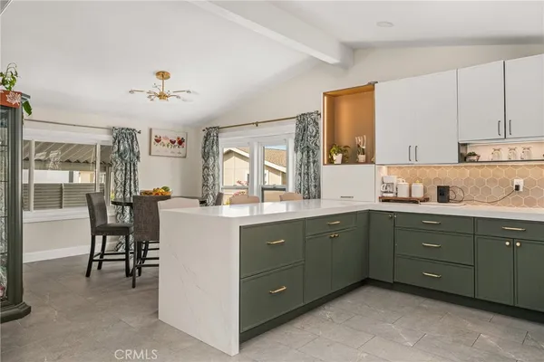 a kitchen with cabinets a sink and appliances