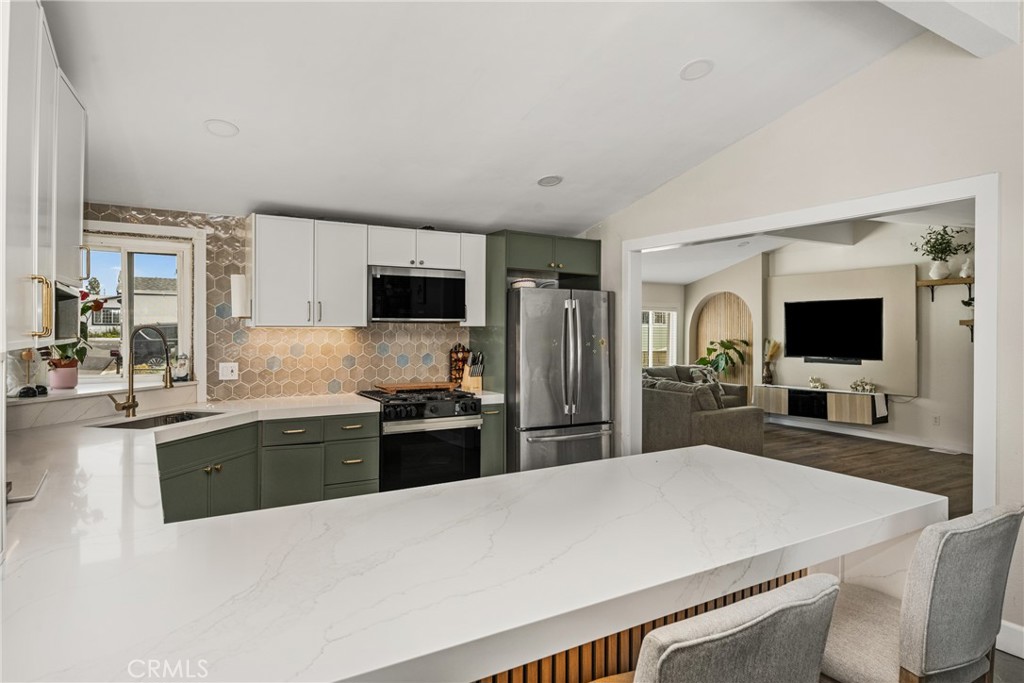 23301 Ridge Rte Drive, Unit 56 Laguna Hills, CA 92653 - Photo 15 of 44 a large kitchen with kitchen island a sink appliances and cabinets