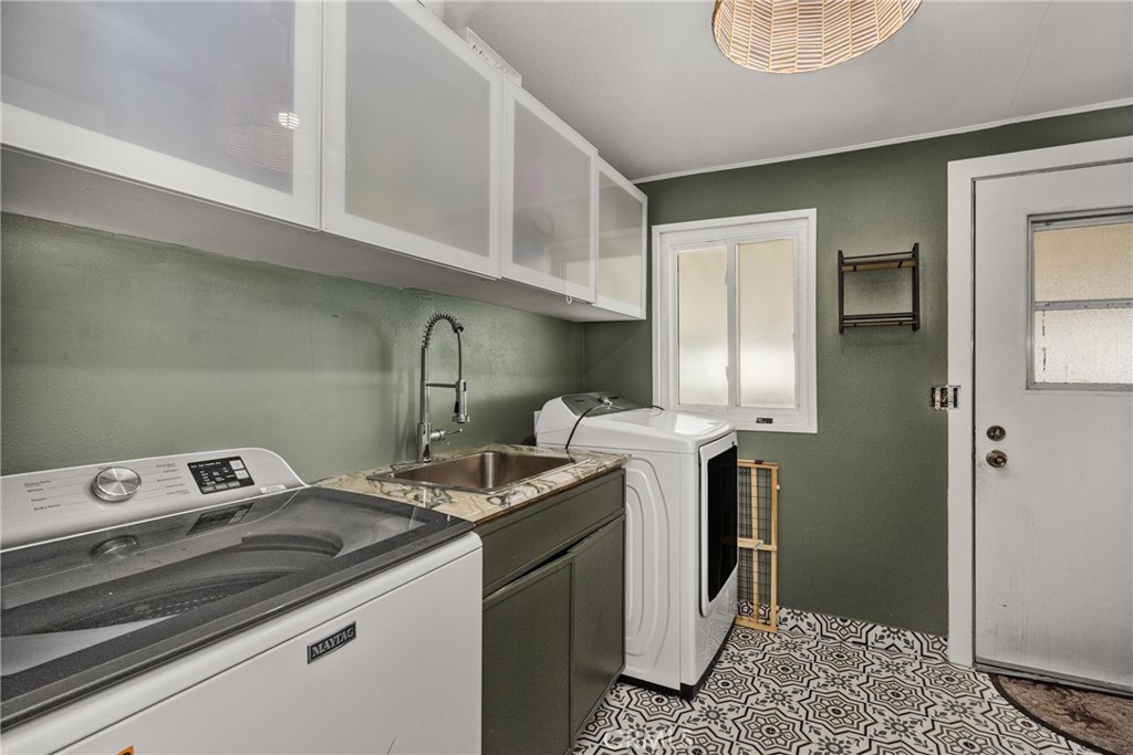 23301 Ridge Rte Drive, Unit 56 Laguna Hills, CA 92653 - Photo 24 of 44 a utility room with washer and dryer