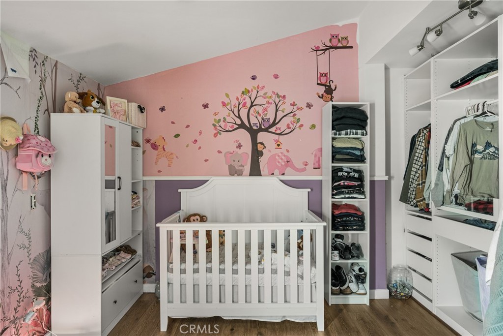 23301 Ridge Rte Drive, Unit 56 Laguna Hills, CA 92653 - Photo 27 of 44 a bedroom with a bed and a white cabinet