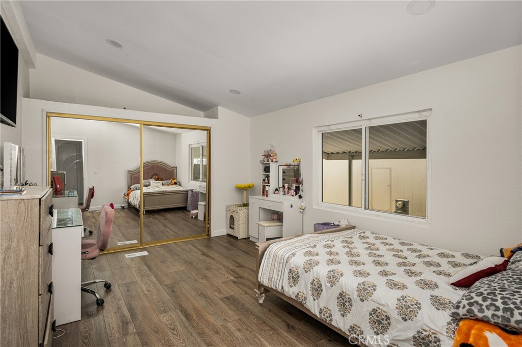 23301 Ridge Rte Drive, Unit 56 Laguna Hills, CA 92653 - Photo 29 of 44 a bed room with a bed and a chair