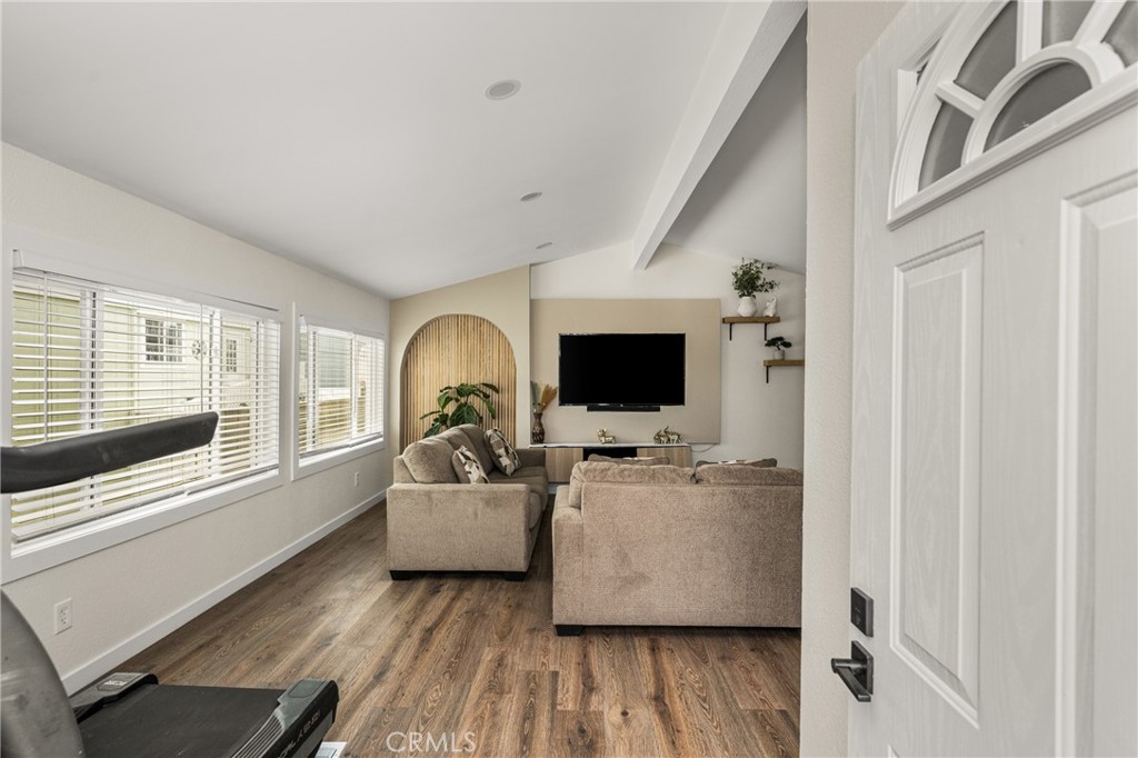 23301 Ridge Rte Drive, Unit 56 Laguna Hills, CA 92653 - Photo 3 of 44 a living room with furniture and a flat screen tv