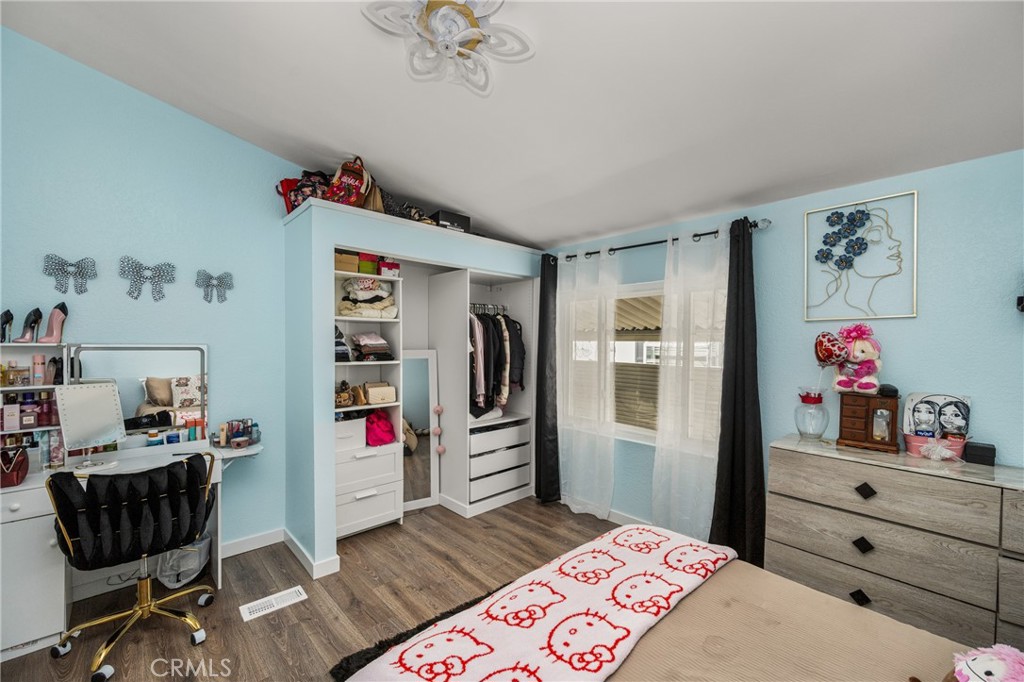 23301 Ridge Rte Drive, Unit 56 Laguna Hills, CA 92653 - Photo 31 of 44 a bedroom with a bed and cabinets