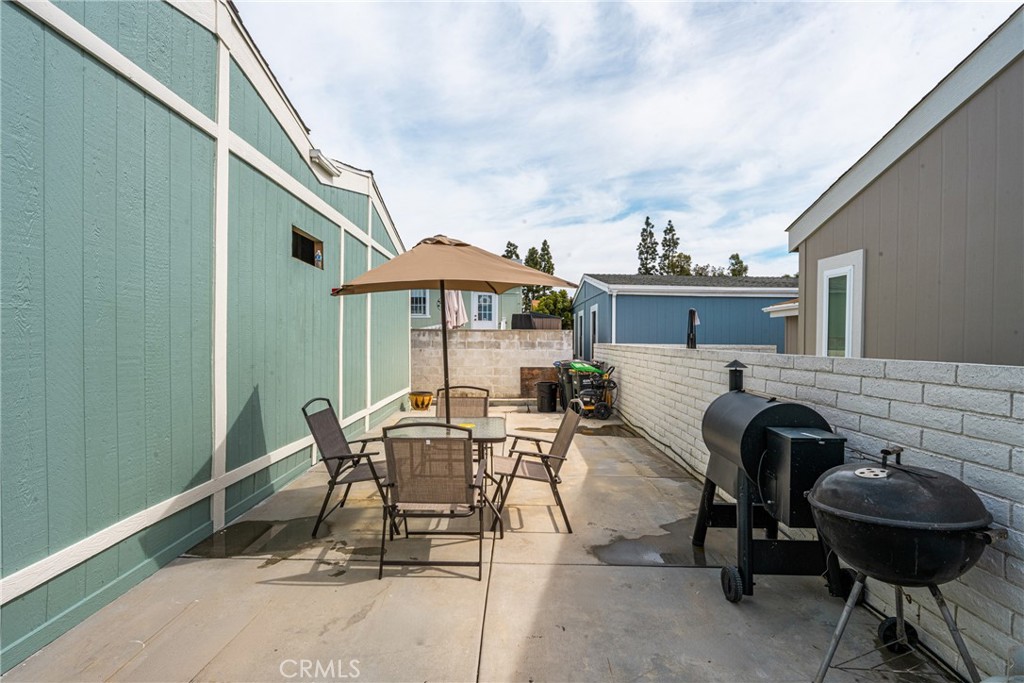 23301 Ridge Rte Drive, Unit 56 Laguna Hills, CA 92653 - Photo 34 of 44 a view of a patio with table and chairs